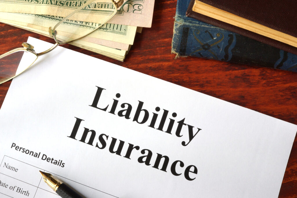 Liability insurance on a wooden table with glasses.