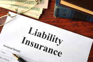 Liability insurance on a wooden table with glasses.