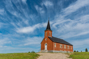 church in a field, most likely utilizes insurance for church buildings