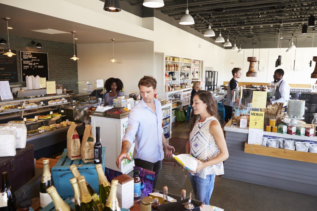 a man with commercial insurance showing a customer a product that he feels safely displaying because of his coverage